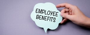 hand holding a speech bubble that says "employee benefits" against a purple background